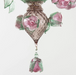 The detail of a pink rose glass chandelier 
